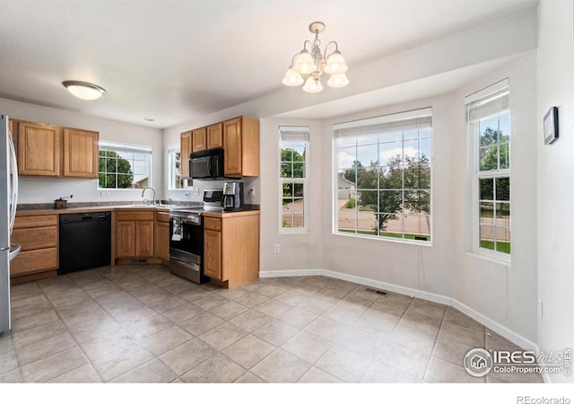 7037 Raleigh St, Wellington, CO 80549 - kitchen featuring black appliances, a chandelier, a sink, baseboards, and pendant lighting