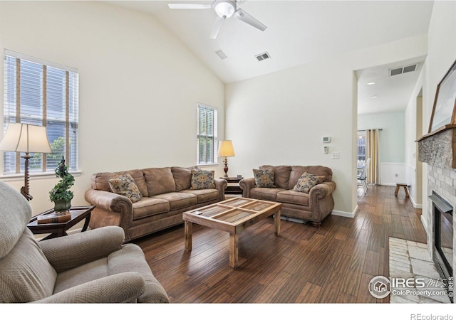 living area featuring a fireplace with flush hearth, wood-type flooring, healthy amount of natural light, ceiling fan, and high vaulted ceiling