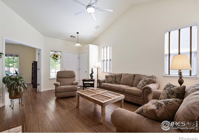 living area with a ceiling fan, high vaulted ceiling, dark wood-style flooring, and baseboards