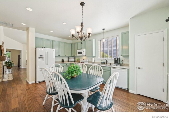dining room with wood finished floors, a chandelier, recessed lighting, and baseboards
