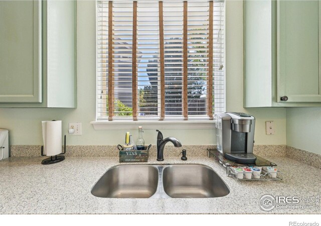 kitchen with a sink and green cabinetry