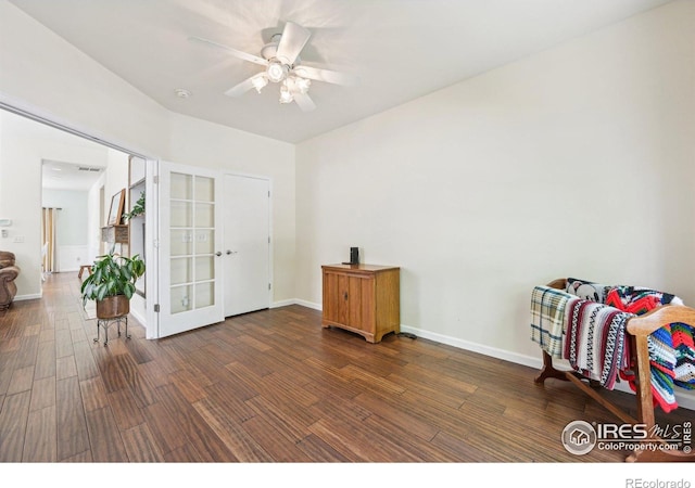 living area featuring wood finished floors, a ceiling fan, french doors, and baseboards