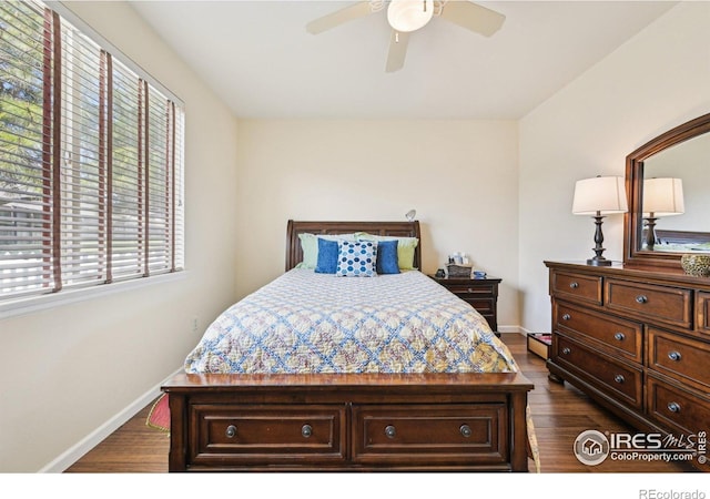 bedroom with dark wood-style flooring, baseboards, and a ceiling fan