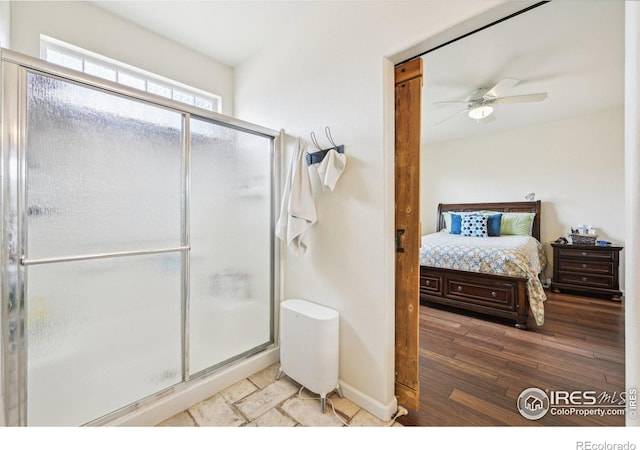 full bath with a stall shower, ensuite bathroom, a ceiling fan, wood finished floors, and baseboards
