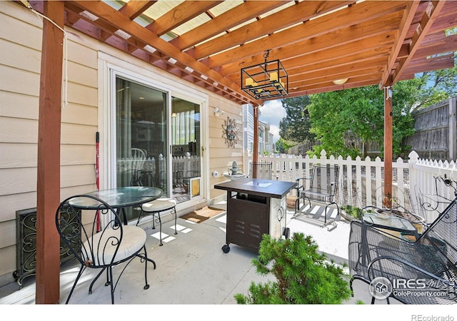 view of patio / terrace featuring fence, outdoor dining area, and an outdoor fire pit