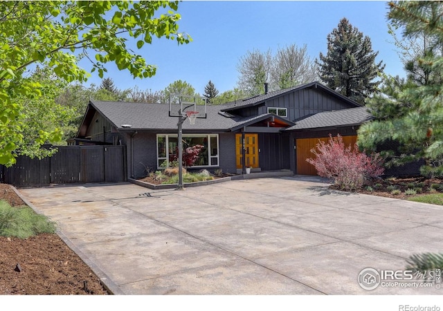 6862 Roaring Fork Trl, Boulder, CO 80301 - view of front of property featuring board and batten siding, fence, a shingled roof, and a gate