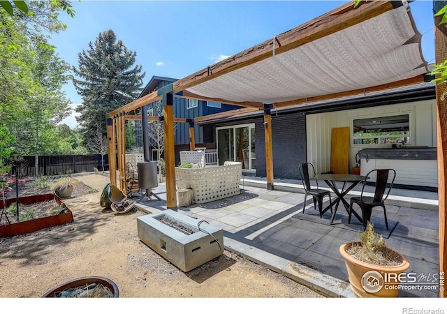 6862 Roaring Fork Trl, Boulder, CO 80301 - view of patio featuring fence, a fire pit, a garden, and outdoor dining space