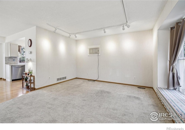 710 Sedge Way, Lafayette, CO 80026 - empty room featuring rail lighting, light colored carpet, and an AC wall unit