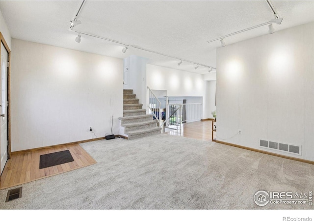710 Sedge Way, Lafayette, CO 80026 - below grade area with rail lighting, carpet floors, and stairway