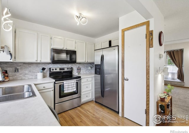 710 Sedge Way, Lafayette, CO 80026 - kitchen with stainless steel appliances, light countertops, backsplash, and white cabinetry