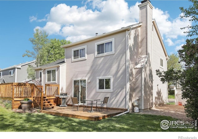 710 Sedge Way, Lafayette, CO 80026 - back of house featuring a wooden deck, a chimney, and a lawn