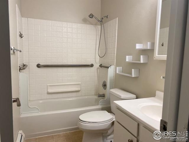 bathroom featuring bathing tub / shower combination, toilet, tile patterned flooring, vanity, and a baseboard radiator
