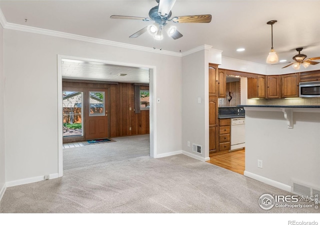kitchen featuring white dishwasher, ceiling fan, light colored carpet, stainless steel microwave, and dark countertops