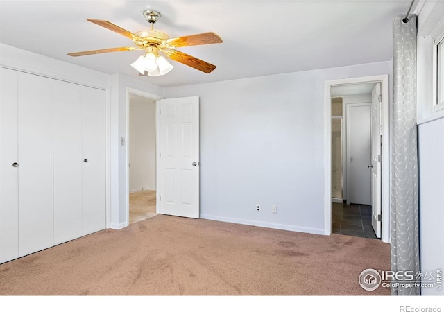 unfurnished bedroom featuring carpet floors, baseboards, a closet, and a ceiling fan