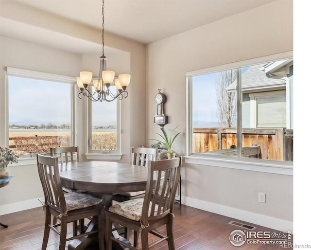 109 Veronica Dr, Windsor, CO 80550 - dining area with a chandelier, wood finished floors, and baseboards