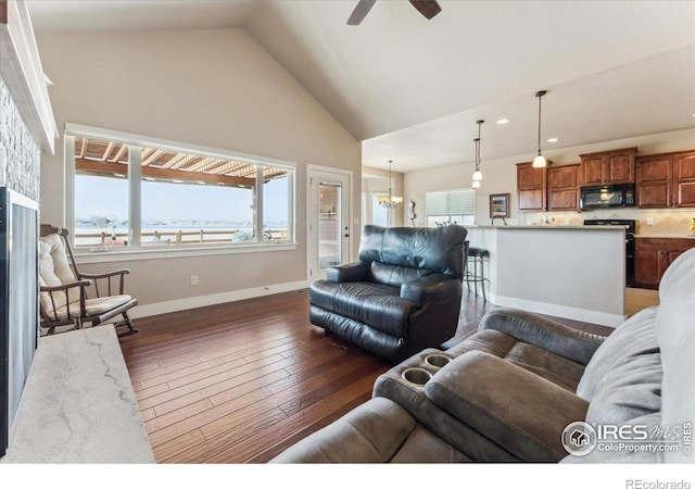 109 Veronica Dr, Windsor, CO 80550 - living room featuring ceiling fan, vaulted ceiling, dark wood-style floors, baseboards, and recessed lighting