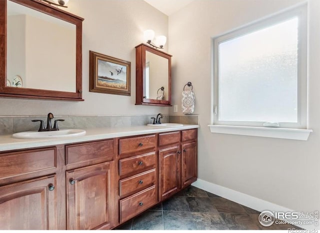 109 Veronica Dr, Windsor, CO 80550 - bathroom with double vanity and baseboards
