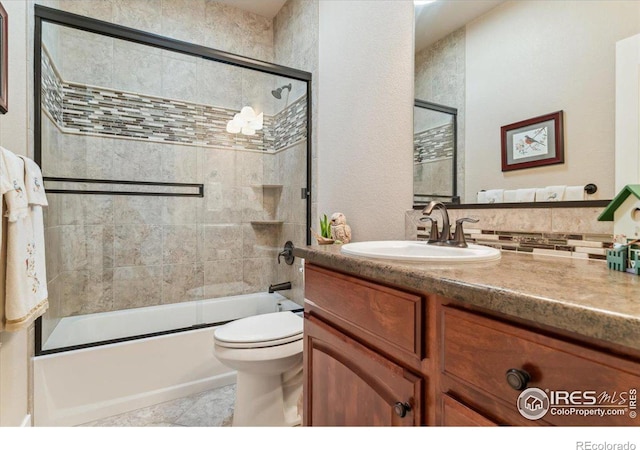 109 Veronica Dr, Windsor, CO 80550 - bathroom with vanity, enclosed tub / shower combo, toilet, and backsplash