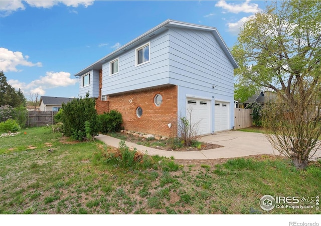 view of property exterior with brick siding, concrete driveway, and an attached garage