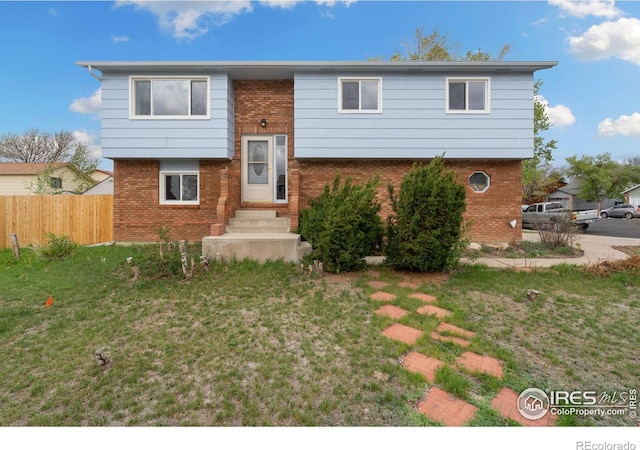 bi-level home featuring brick siding and entry steps