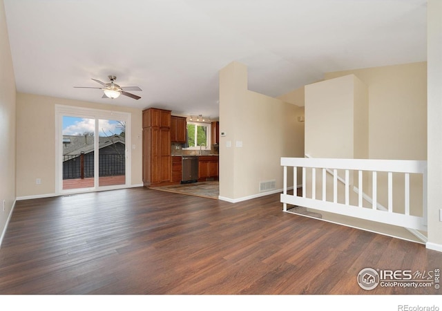 unfurnished living room featuring dark wood-style floors and baseboards