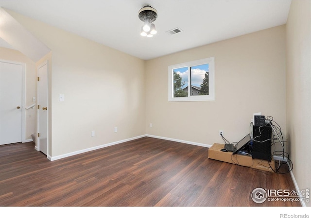 unfurnished room featuring wood finished floors and baseboards