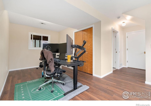 office space with wood finished floors and baseboards