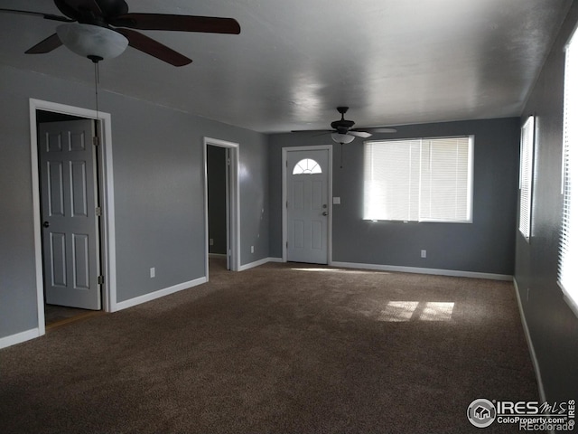 unfurnished living room featuring a ceiling fan, carpet, and baseboards