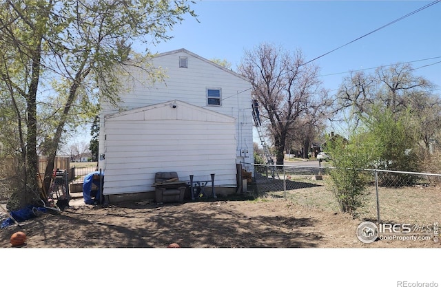 view of side of home with fence