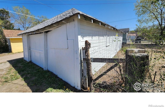 view of outbuilding with fence and an outdoor structure