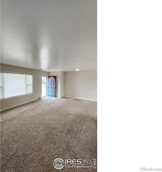 214 Charmony Pl, Sterling, CO 80751 - spare room with baseboards and carpet