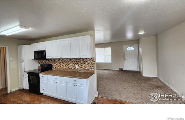 214 Charmony Pl, Sterling, CO 80751 - kitchen featuring black appliances, white cabinetry, baseboards, and dark countertops