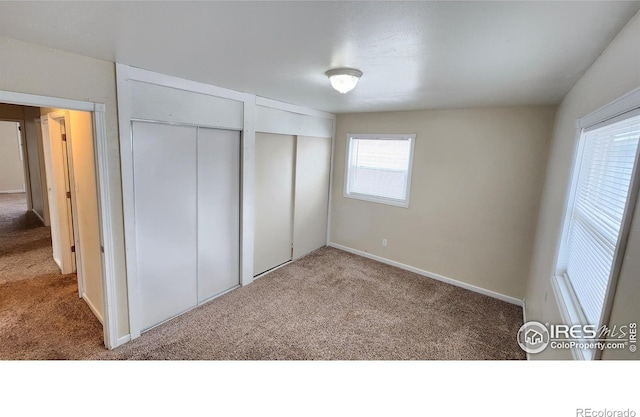 214 Charmony Pl, Sterling, CO 80751 - unfurnished bedroom with carpet floors, multiple closets, and baseboards