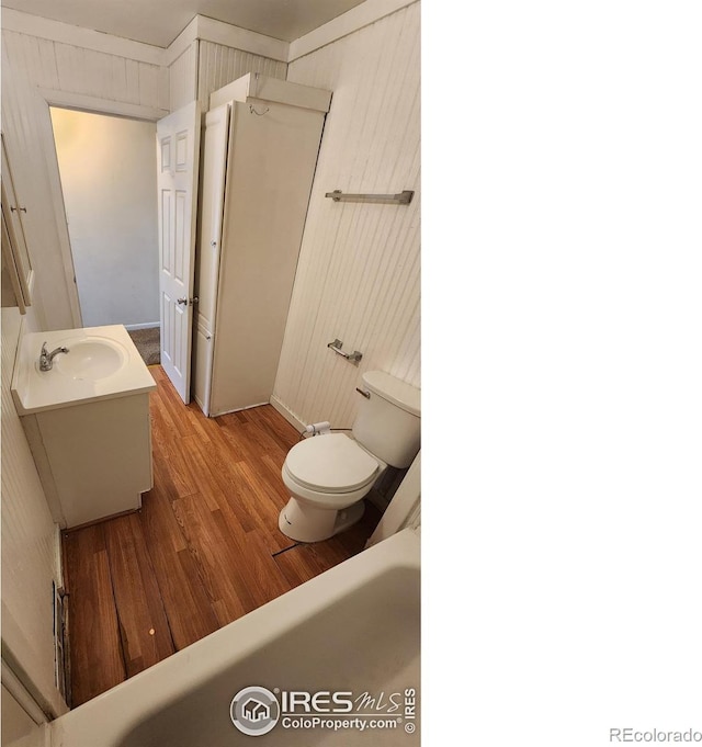 214 Charmony Pl, Sterling, CO 80751 - bathroom featuring toilet, wood finished floors, and vanity