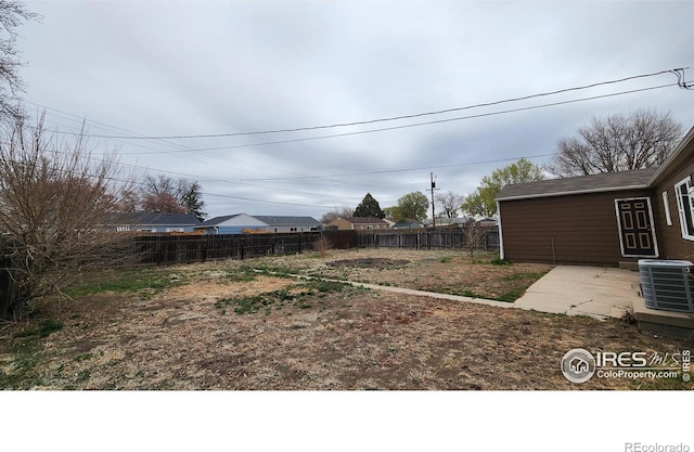 214 Charmony Pl, Sterling, CO 80751 - view of yard featuring fence, central AC unit, and a patio