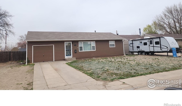 214 Charmony Pl, Sterling, CO 80751 - single story home with an attached garage, concrete driveway, and fence