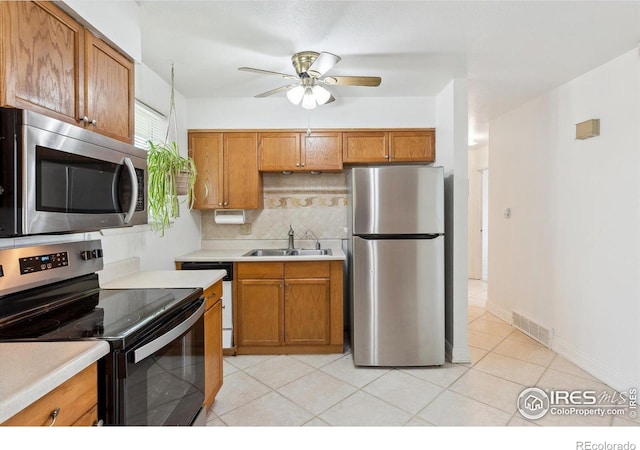 200 Perry St, Denver, CO 80219 - kitchen with stainless steel appliances, a sink, a ceiling fan, and light countertops