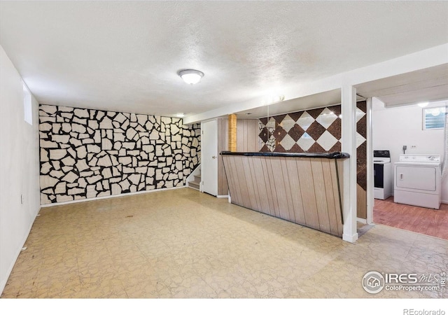 200 Perry St, Denver, CO 80219 - finished basement featuring washing machine and clothes dryer, tile patterned floors, a textured ceiling, an accent wall, and stairs