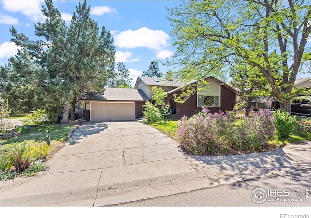 2702 W 23rd St, Greeley, CO 80634 - view of front of house with an attached garage, driveway, and stucco siding