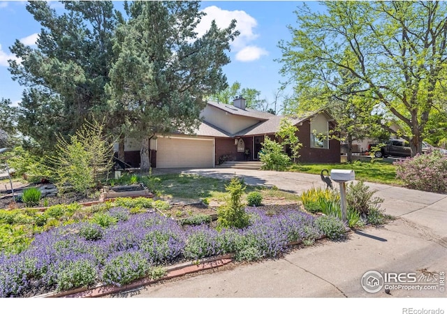 2702 W 23rd St, Greeley, CO 80634 - view of front facade featuring driveway, a garage, and stucco siding