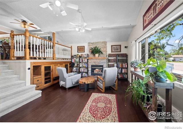 2702 W 23rd St, Greeley, CO 80634 - living room with a ceiling fan, wood finished floors, vaulted ceiling, a stone fireplace, and stairway