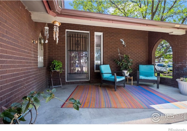 2702 W 23rd St, Greeley, CO 80634 - doorway to property with brick siding and covered porch