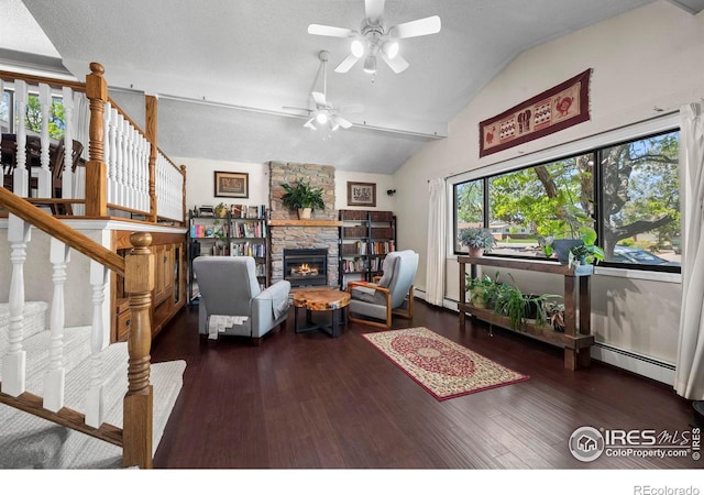 2702 W 23rd St, Greeley, CO 80634 - living area featuring a ceiling fan, vaulted ceiling, wood finished floors, stairway, and a stone fireplace