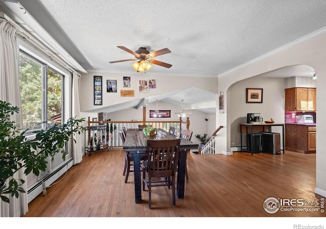 2702 W 23rd St, Greeley, CO 80634 - dining room with arched walkways, ceiling fan, wood finished floors, a textured ceiling, and plenty of natural light