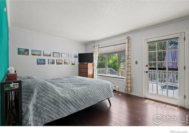 2702 W 23rd St, Greeley, CO 80634 - bedroom with access to outside, wood finished floors, ornamental molding, a textured ceiling, and baseboard heating