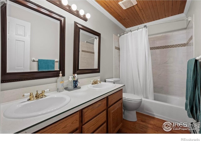 2702 W 23rd St, Greeley, CO 80634 - bathroom with ornamental molding, toilet, double vanity, shower / tub combo with curtain, and wood finished floors