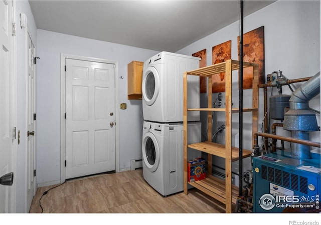 2702 W 23rd St, Greeley, CO 80634 - clothes washing area featuring stacked washer / drying machine and a baseboard radiator