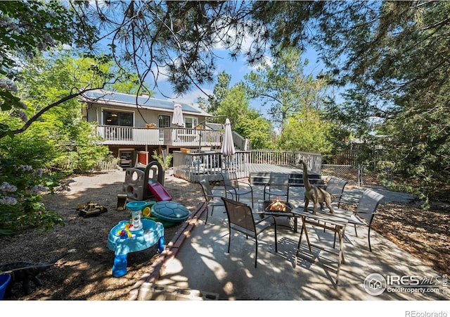 2702 W 23rd St, Greeley, CO 80634 - view of patio / terrace featuring a fire pit and a deck