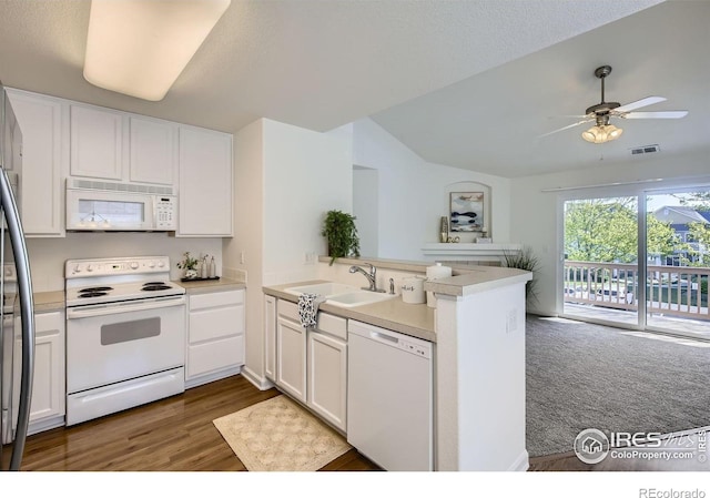 kitchen with white appliances, a sink, a peninsula, white cabinetry, and a ceiling fan
