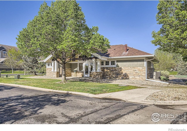 view of front of house featuring stone siding and a front yard
